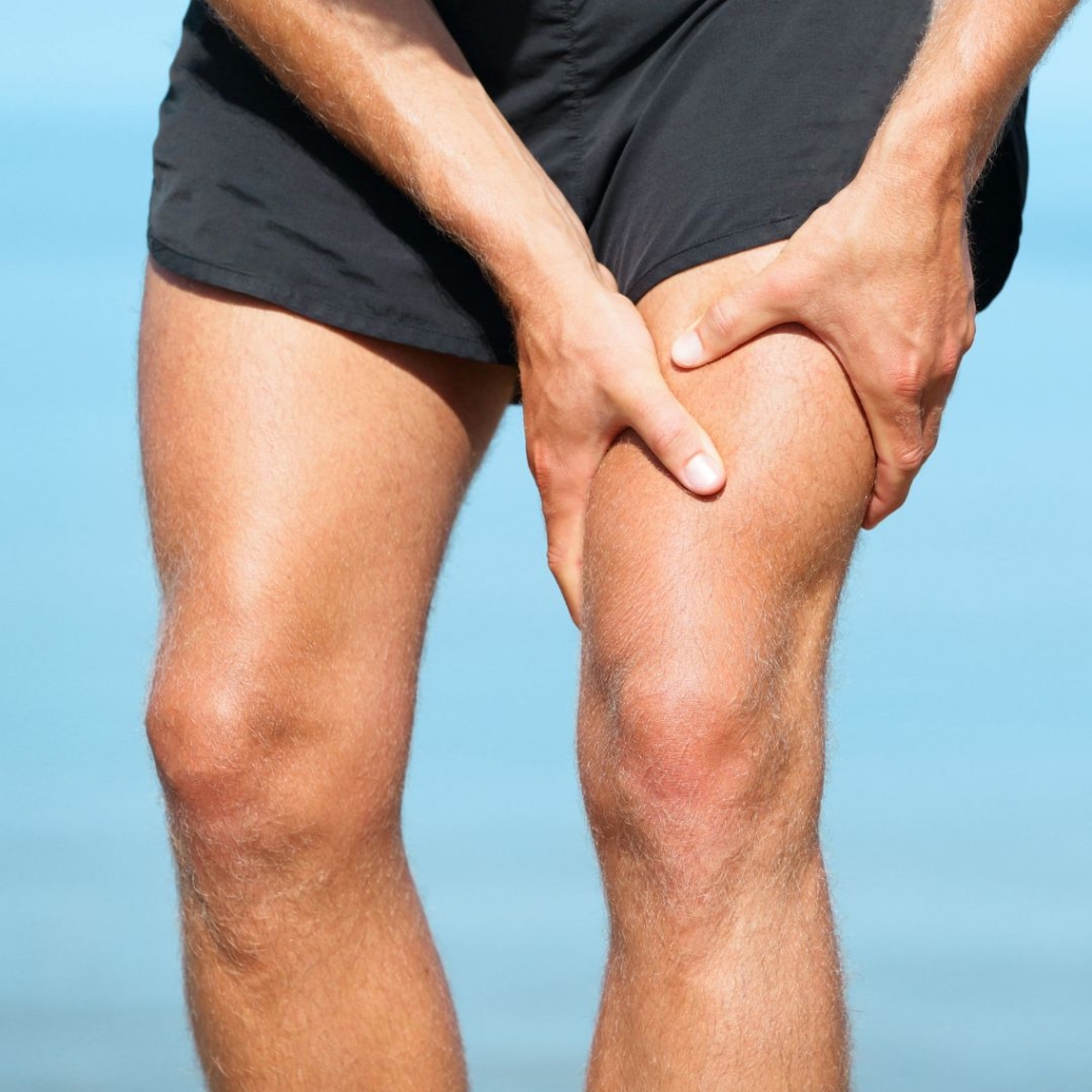 an athlete holding their thigh