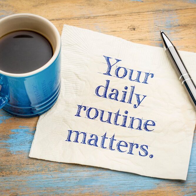 Your daily routine matters - handwriitng on napkin with a cup of coffee